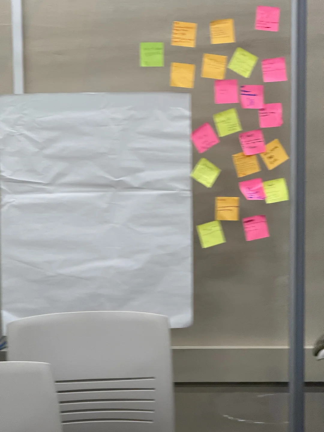Colorful handwritten sticky notes arranged beside a large sheet of paper